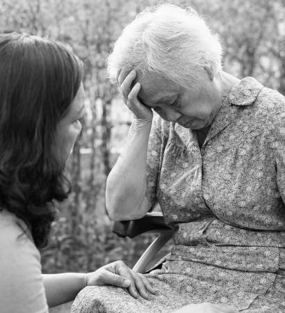 Neglected elderly woman crying talking to loved one