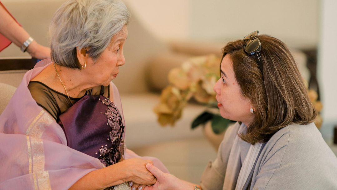 elderly woman with family member